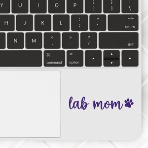 Purple Lab Mom decal with a paw print placed on a laptop.