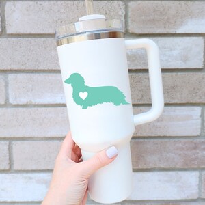Green Long Haired Dachshund decal with a heart on a white tumbler.