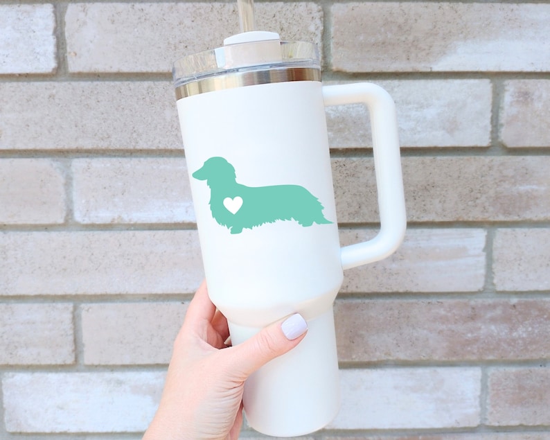 Green Long Haired Dachshund decal with a heart on a white tumbler.