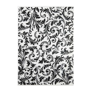 May include: A clear plastic sheet with a black and white floral pattern. The pattern is a repeating design of leaves and swirls.