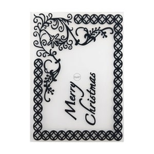 May include: Clear plastic sheet with a black design of a decorative frame and the words "Merry Christmas".