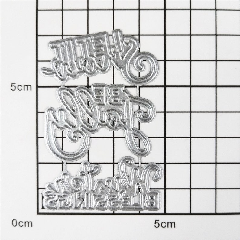 以下が含まれることがあります： スクラップブッキングやカード作り用の金属製ダイカット。ダイには「She'll Be Joy」と「Blessings Winter」の文字が刻まれています。