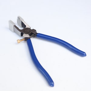 May include: Blue handled pliers with a silver metal head and a small brass screw. The pliers are designed for crimping.