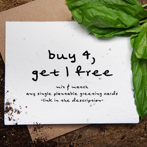 May include: A white card with the text "buy 4, get 1 free" in black handwritten font. The card is surrounded by soil, a brown envelope, and fresh green basil leaves. The offer is for plantable greeting cards.