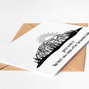 May include: A white greeting card with a black mountain illustration and the text "You've made it! The best view comes after the hardest climb." The card is inside a brown envelope.