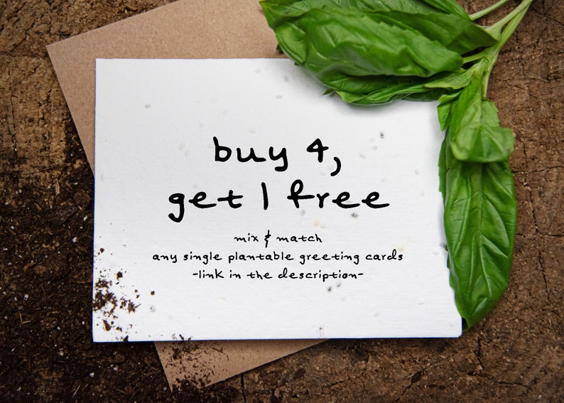 May include: A white card with the text "buy 4, get 1 free" in black handwritten font. The card is surrounded by soil, a brown envelope, and fresh green basil leaves. The offer is for plantable greeting cards.