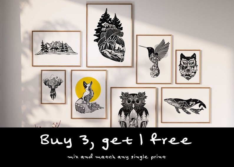 May include: A selection of framed art prints with black and white nature-themed illustrations. Designs include mountains, a heart-shaped landscape, a hummingbird, a wolf, a deer, a fox with a yellow background, an owl, and whales. The text "Buy 3, get 1 free" is also visible.