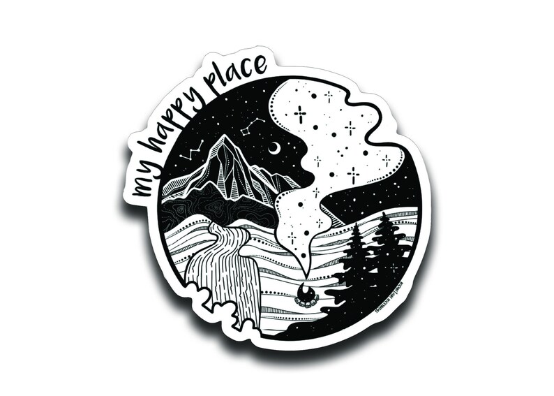 May include: Black and white sticker with a mountain, river, trees, and stars. The text "my happy place" is written around the edge of the sticker.
