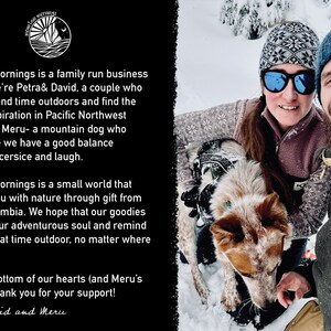 May include: A smiling couple and a dog pose in a snowy outdoor setting. The image includes the text "Mountain Mornings" and a description of the business and its values. The people are wearing winter hats and jackets.