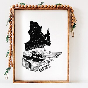 May include: A framed black and white art print featuring the outline of Quebec, Canada. The top portion depicts a starry night sky with constellations, while the bottom shows a landscape with animals. The word "QUEBEC" is written at the bottom.