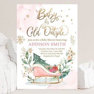 May include: A baby shower invitation with the text "Baby it's Cold Outside" in gold script. The invitation features a pink watercolor background, snowflakes, and a sleigh with gifts. The invitation is for Addison Smith.
