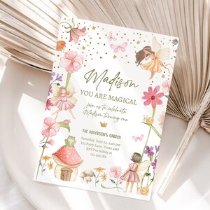 May include: A whimsical fairy-themed birthday party invitation with a pink and green color scheme. The invitation features a fairy with wings, a mushroom house, and the text "Madison You Are Magical join us to celebrate Madison turning one The Anderson's Garden Saturday, June 22, 2:00 pm 123 Party Lane, Texas 4567 RSVP to Ashley at 123.456.789"