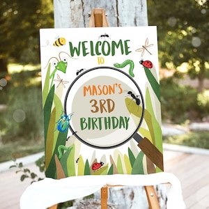 May include: A welcome sign for a bug-themed birthday party. The sign features a magnifying glass with the text "Welcome to Mason's 3rd Birthday" inside. The background is green with various bugs and insects, including ants, ladybugs, butterflies, and a praying mantis.