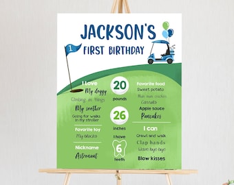 May include: A green and blue illustrated first birthday poster for a boy named Jackson. The poster features a golf cart, golf balls, and a golf club. It includes details about the child's age, weight, height, favorite foods, and activities. The poster also includes the child's nickname, "Astronaut".