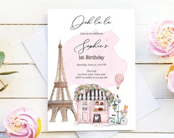 May include: A pink and white invitation with a watercolor background featuring the Eiffel Tower, a Parisian cafe, and a hot air balloon. The text reads "Oh la la Join us to celebrate Sophie's 1st Birthday Saturday, June 22, 2:00 PM The Cafe 123 Party Lane, Texas 4567 RSVP to Ashley at 123.456.789 DESIGNMYPARTYSTUDIO.COM"
