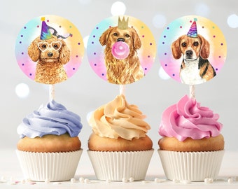 May include: Three cupcake toppers featuring watercolor illustrations of dogs wearing party hats. The toppers are on top of cupcakes with purple, yellow, and pink frosting.