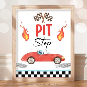 May include: A printable sign with a red race car, checkered flags, and the words "PIT Stop" in red and black. The sign is perfect for a race car themed party.