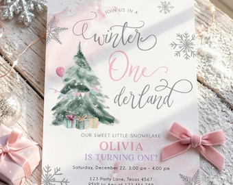 May include: A rectangular invitation card featuring a watercolor Christmas tree, pink and grey text reading Winter One derland, and the name Olivia. The card includes event details, snowflake graphics, and a soft pink velvet bow attached to the side.