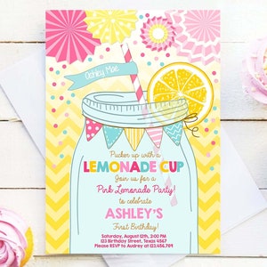 May include: A yellow and pink lemonade party invitation with a mason jar filled with lemonade and a lemon slice on top. The text reads "Pucker up with a LEMONADE CUP Join us for a Pink Lemonade Party! to celebrate ASHLEY'S First Birthday! Saturday, August 12th, 2:00 PM 123 Birthday Street, Texas 4567 Please RSVP to Audrey at 123,456,789 DESIGN MY PARTY STUDIO"
