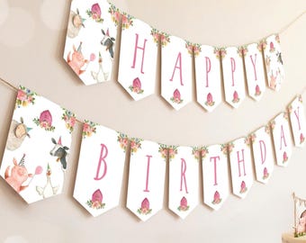 May include: A two-tiered party banner featuring white pennants with pink lettering spelling out HAPPY BIRTHDAY. The pennants are decorated with watercolour illustrations of farm animals wearing party hats and floral accents, all strung on twine.