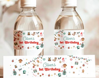 May include: Two clear water bottles with white caps and labels that read "Oliver's 1st Birthday." The labels feature festive Christmas-themed illustrations in red, green, and white. A matching banner is displayed below the bottles.