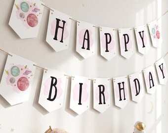 May include: A two-tiered Happy Birthday banner featuring white pennants with black lettering and watercolor-style pink planet illustrations. The banner is strung on twine and includes decorative end pieces with space-themed graphics.