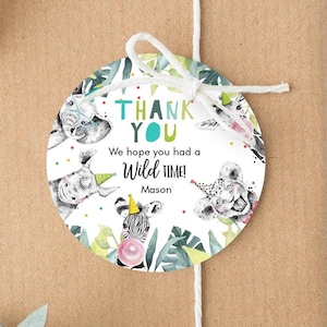 May include: Round thank you sticker with a white background and colorful jungle animals. The text reads "Thank You" in blue and green letters. Below the text it says "We hope you had a Wild Time!" with the name "Mason" underneath.