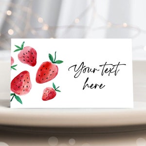 May include: White card with a watercolor illustration of red strawberries and green leaves. The text "Your text here" is written in black cursive.