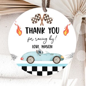 May include: Round thank you tag with a blue race car, checkered flag, and flames. The text reads "Thank you for racing by! Love, Mason".