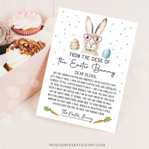 May include: A light blue and green Easter bunny with pink glasses holding a sign that says "From the desk of the Easter Bunny" and a message to Olivia. The sign is decorated with colourful Easter eggs.