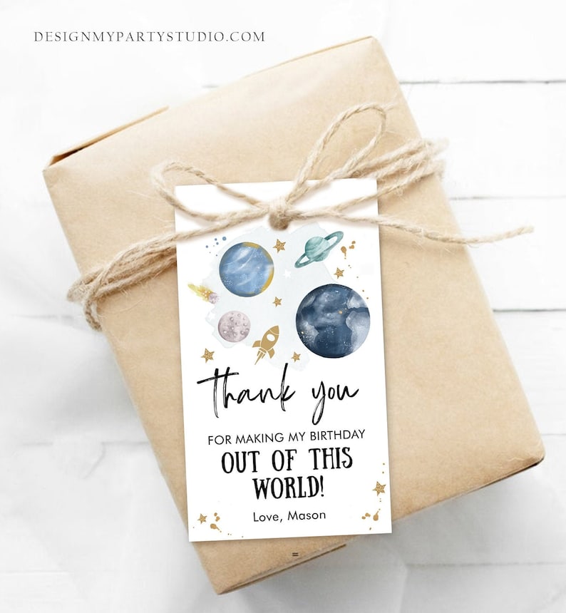 May include: A white thank you tag with a blue and gold space theme. The tag says "Thank you for making my birthday out of this world! Love, Mason".