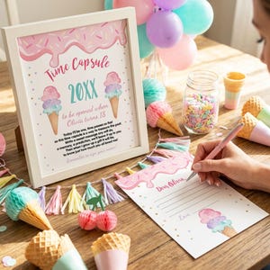 May include: A white framed sign titled Time Capsule 20XX with ice cream cone illustrations and text instructions for a child. Beside it, a matching stationery sheet with lines for writing, decorated with pink frosting and sprinkles, and a pink pen.