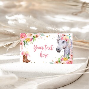 May include: Printable party favor tag featuring a white horse with a pink floral crown, pink cowboy boots, and gold glitter. The text "Your text here" is written in pink.