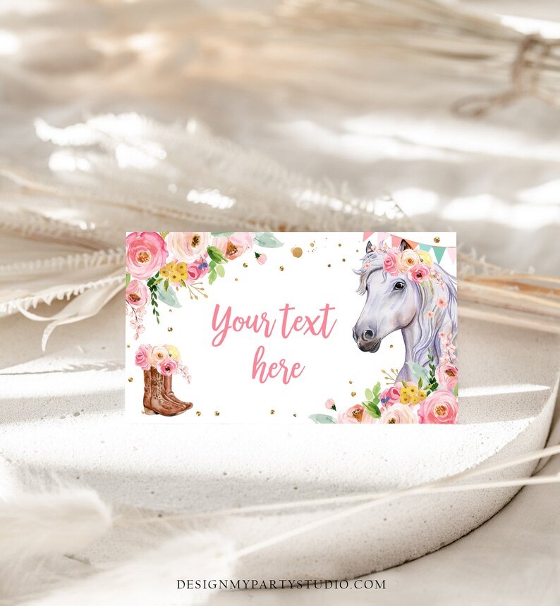 May include: Printable party favor tag featuring a white horse with a pink floral crown, pink cowboy boots, and gold glitter. The text "Your text here" is written in pink.