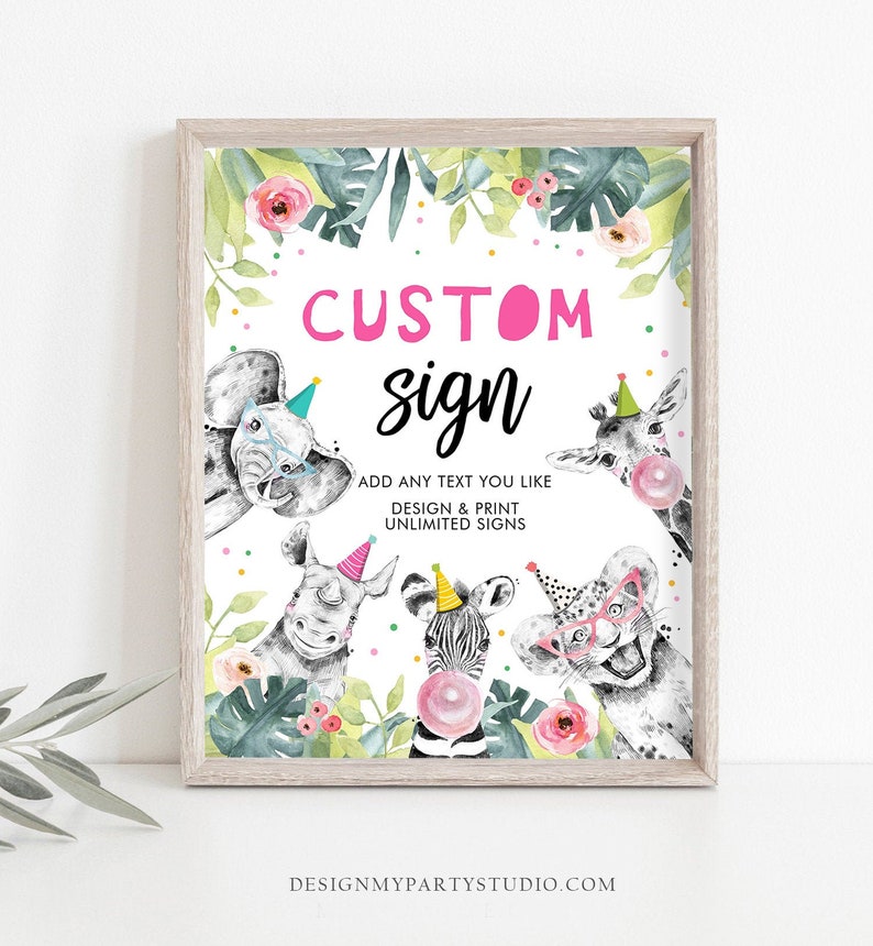 May include: A printable sign with a jungle theme featuring a pink and white custom sign with the text "CUSTOM sign" and the text "ADD ANY TEXT YOU LIKE DESIGN & PRINT UNLIMITED SIGNS". The sign features a black and white illustration of a giraffe, elephant, rhino, zebra, and lion wearing party hats and glasses.