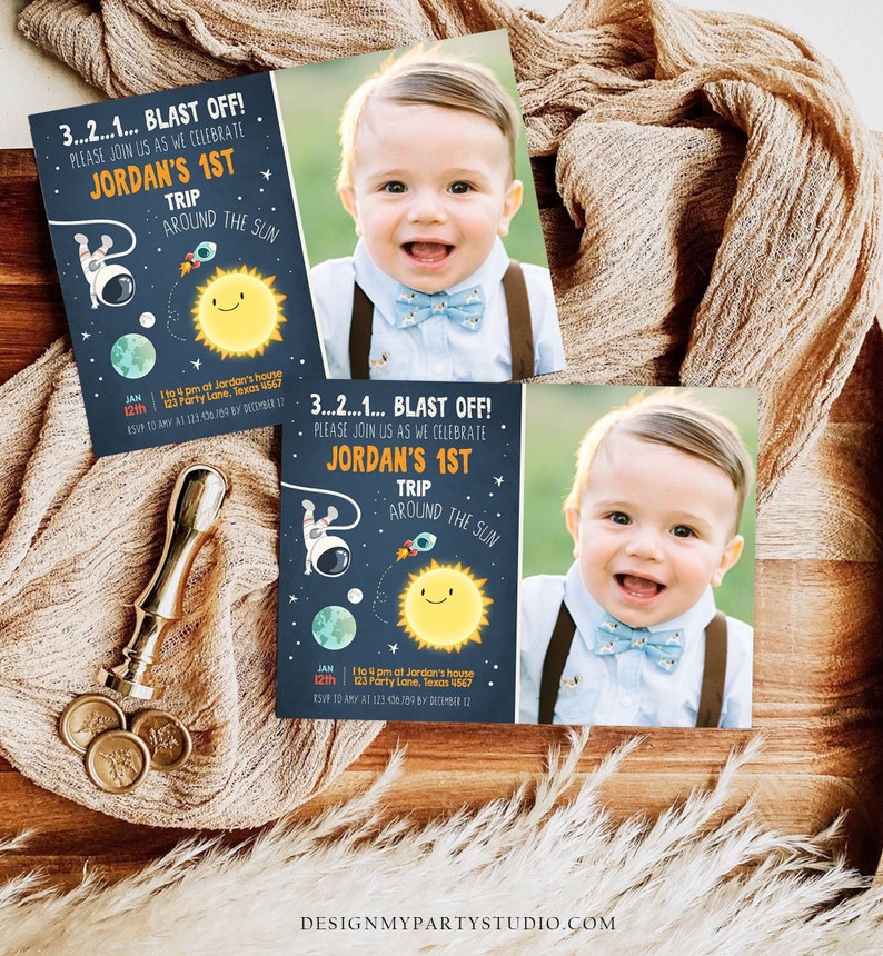 May include: A blue and white space-themed birthday invitation with a photo of a baby boy. The invitation says "3...2...1... BLAST OFF! Please join us as we celebrate Jordan's 1st Trip Around the Sun." The invitation also includes a date and time for the party.