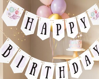 May include: A white pennant banner featuring the black text HAPPY BIRTHDAY. Each pennant displays a light purple watercolor wash background with small gold stars and illustrations of planets. The banner is strung on thin twine for hanging.