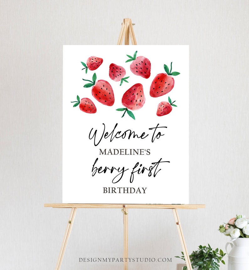 Peut inclure: Affiche de bienvenue pour le premier anniversaire de Madeline, avec un fond blanc et des fraises rouges en aquarelle.