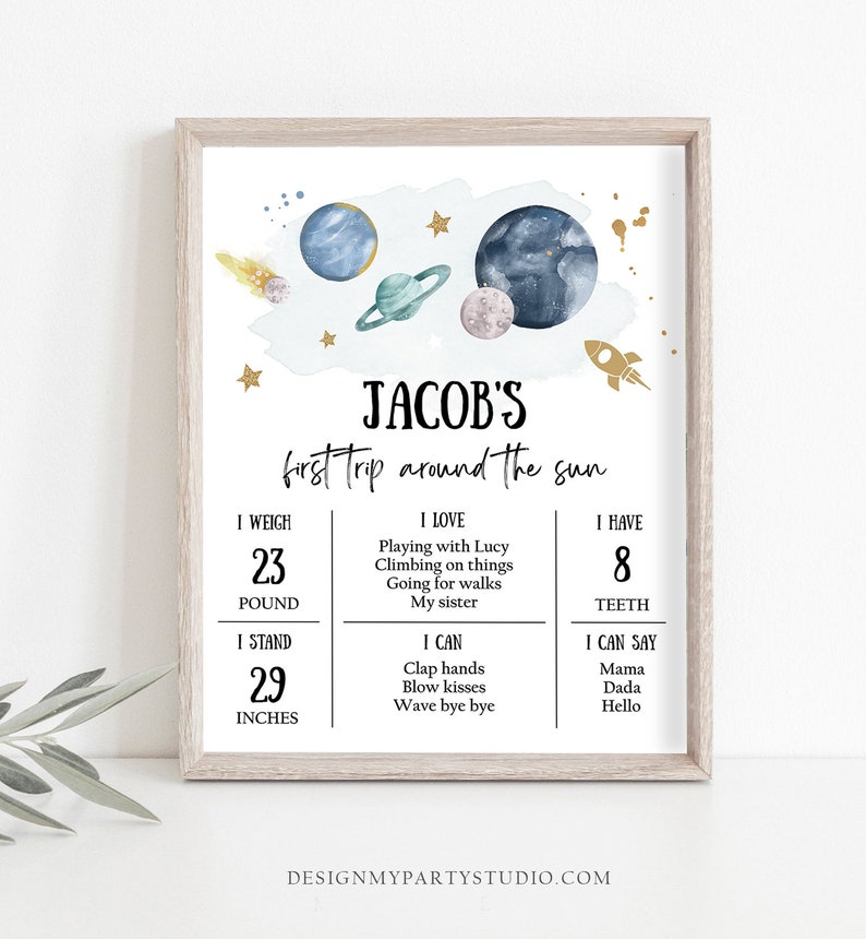 May include: A blue and white illustrated poster with a space theme. The poster says "Jacob's first trip around the sun". It includes details about Jacob's weight, height, number of teeth, and things he loves and can do.