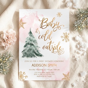 May include: A rectangular baby shower invitation card featuring a watercolour green pine tree, gold foil snowflakes, and pink watercolour accents. The text reads: Baby it's cold outside, JOIN US FOR A BABY SHOWER HONORING ADDISON SMITH, Saturday, December 22, 3:00 pm - 4:00 pm, 123 Party Lane, Texas 4567, RSVP to Amy at 123.456.789, Registered at Target.