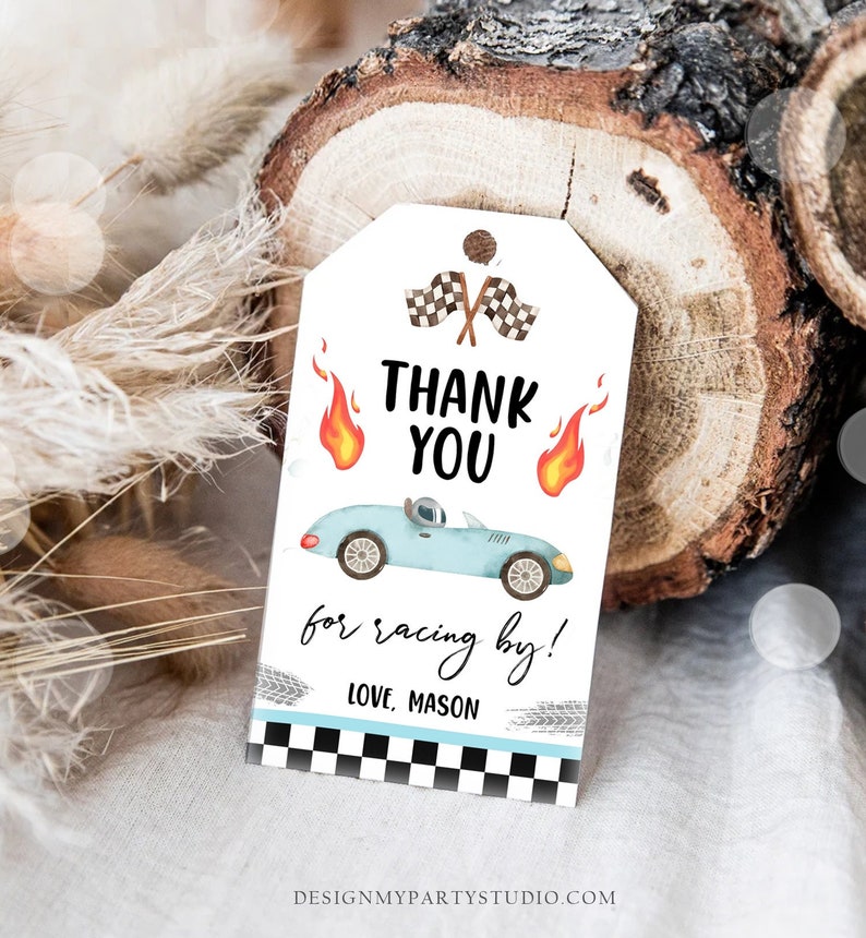 May include: A white thank you tag with a blue race car, checkered flags, and flames. The text reads "Thank You for racing by! Love, Mason".