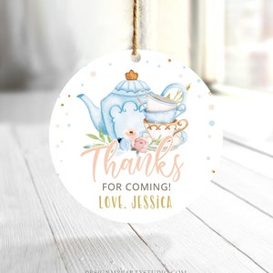 May include: Round white thank you tag with a blue teapot and teacups, pink and blue flowers, and gold glitter. The text reads "Thanks for coming! Love, Jessica".