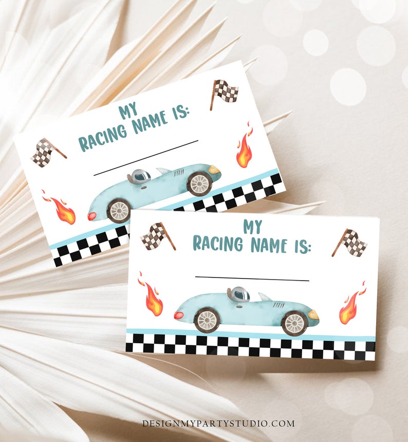 May include: Two blue and white racing car themed name tags with the text "My Racing Name Is:" and a blank space for writing. The tags are decorated with chequered flags, flames, and a blue race car.