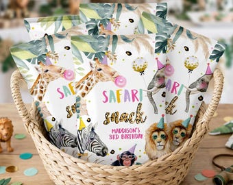 May include: A woven wicker basket filled with multiple snack bags featuring a safari theme. The bags display illustrations of a giraffe, zebra, elephant, lion, and monkey wearing party hats, with the text Safari snack and Maddison's 3rd Birthday.