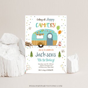 May include: A blue and brown camper van with a white roof and a yellow awning. The van has a window and a door. There are colorful flags and lights strung across the front of the van. The text "Calling all Happy Campers!" is at the top of the invitation. The text "Join us to celebrate Jackson's 9th Birthday!" is in the middle of the invitation. The text "Saturday, June 22, 4:00 pm Jackson's Campground 123 Party Lane, Texas 4567 RSVP to Amy at 123.956.789" is at the bottom of the invitation.