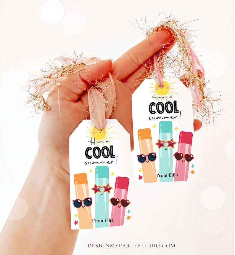 May include: Two white gift tags with a sun and three colorful lip balm tubes with sunglasses. The text on the tags reads "Have a COOL summer!" and "From Ellie".