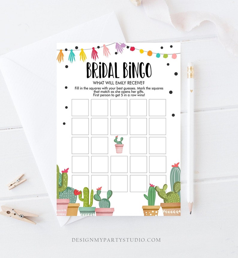May include: A printable bridal bingo card with a cactus theme. The card has a white background with black dots and a colorful garland at the top. The card has a 5x5 grid with squares for marking off bingo spaces. The text on the card reads 'Bridal Bingo', 'What will Emily receive?', 'Fill in the squares with your best guesses. Mark the squares that match as she opens her gifts. First person to get 5 in a row wins!' and 'DesignMyPartyStudio.com'.
