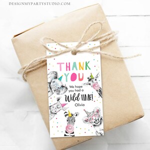 May include: Thank you card with a white background and colourful confetti. The card features a cartoon elephant, giraffe, rhino, zebra, and lion wearing party hats. The text reads "Thank You" in colourful letters and "We hope you had a Wild Time! Olivia".