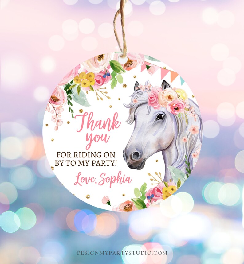 May include: A round, white thank you tag with a floral border and a white horse with a pink flower crown. The text on the tag reads: 'Thank you for riding on by to my party! Love, Sophia'.