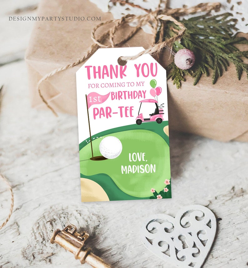 May include: Pink and green thank you tag with a golf cart and golf ball. The text reads "Thank you for coming to my 1st Birthday Par-Tee. Love, Madison."